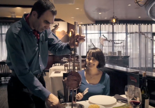 Tableside carving service captured in a steakhouse